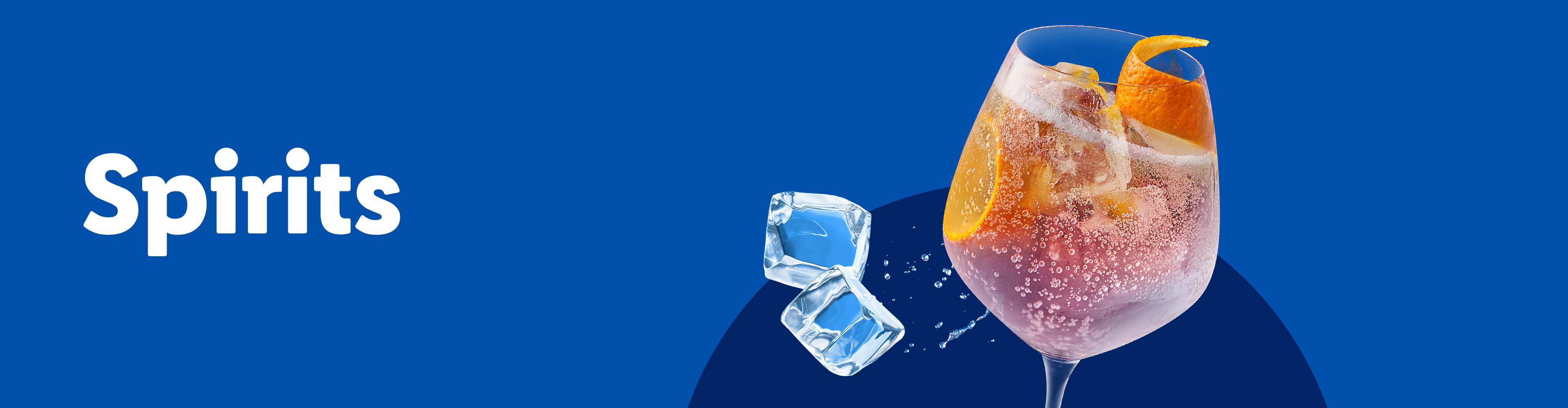 A refreshing pink cocktail with orange slices and ice cubes on a blue background.
