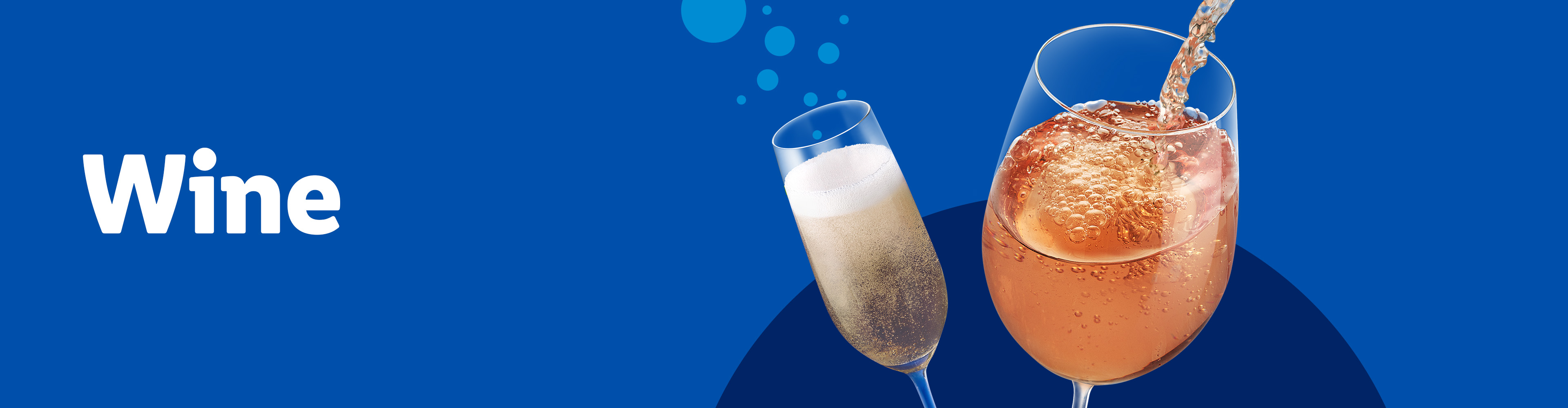 Two glasses of sparkling beverages, one being poured, against a blue background.