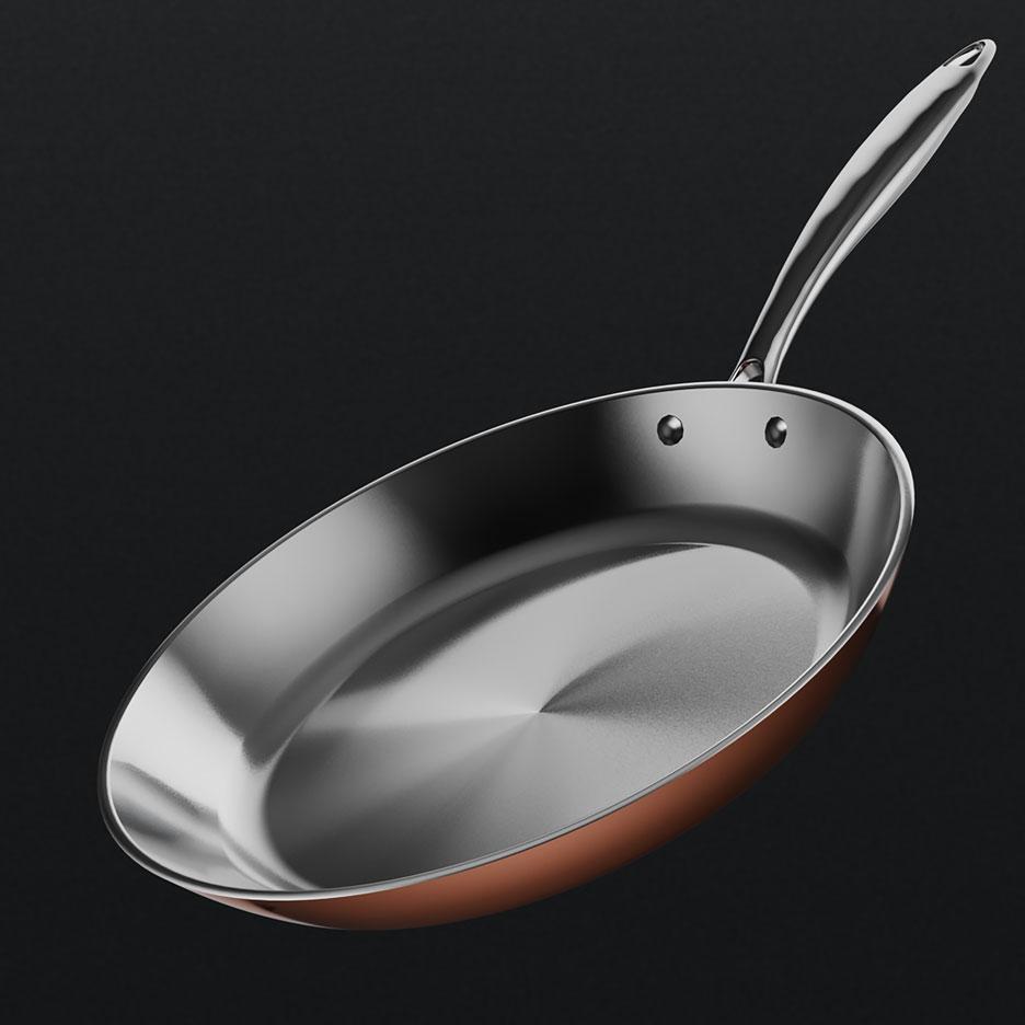Copper-colored frying pan with a silver-colored interior and handle.