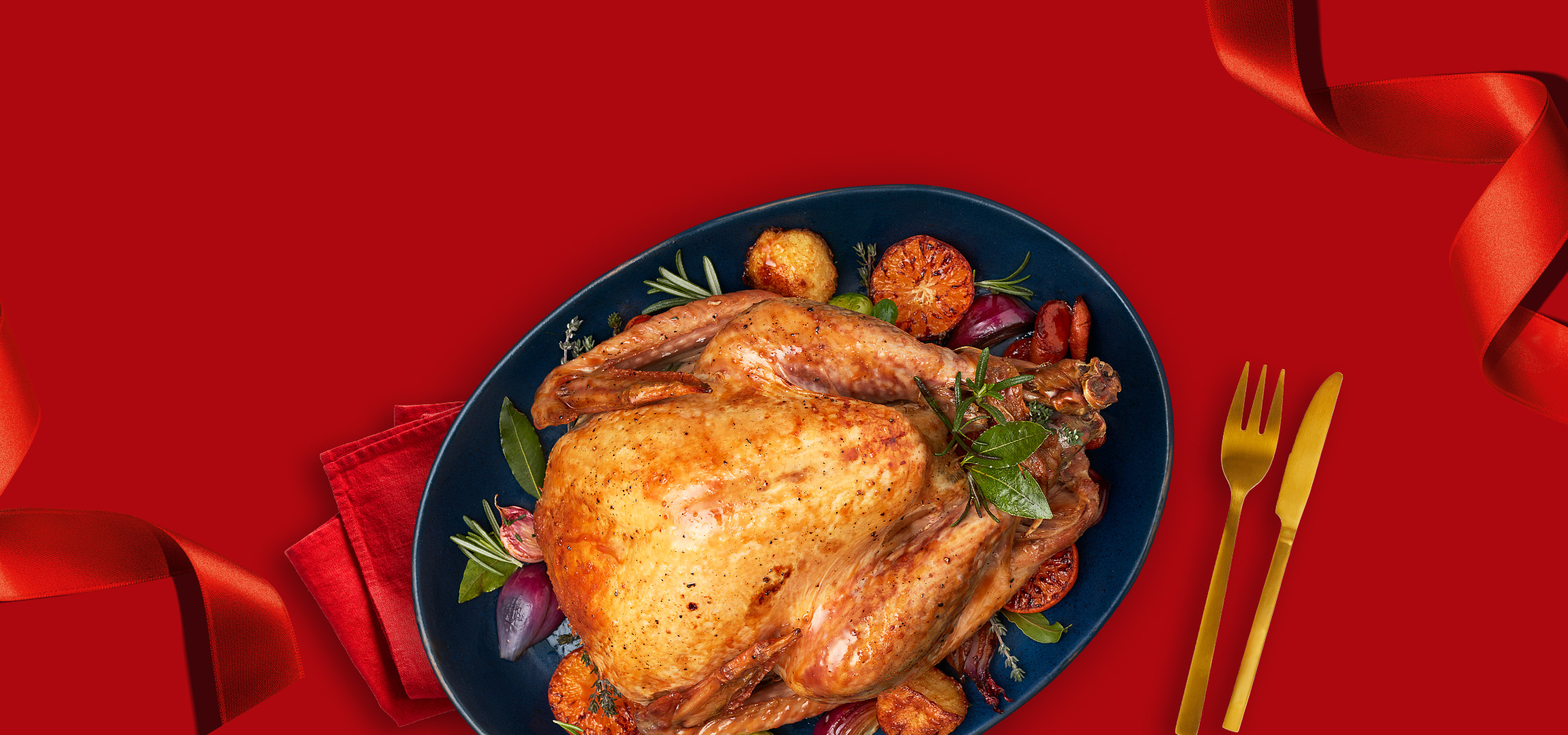 Roasted chicken and potatoes on a red background with a red ribbon.