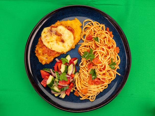 Chicken parmesan with spaghetti and a side salad on a blue plate.