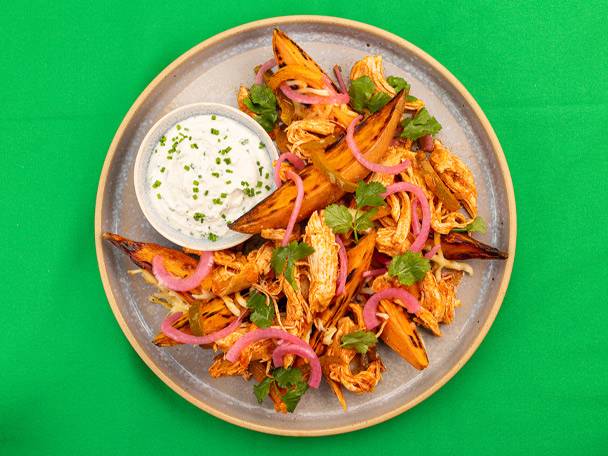 Pulled chicken and sweet potato wedges with pickled red onion and a chive dip.