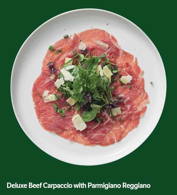 Deluxe Beef Carpaccio with Parmigiano Reggiano on a white plate.