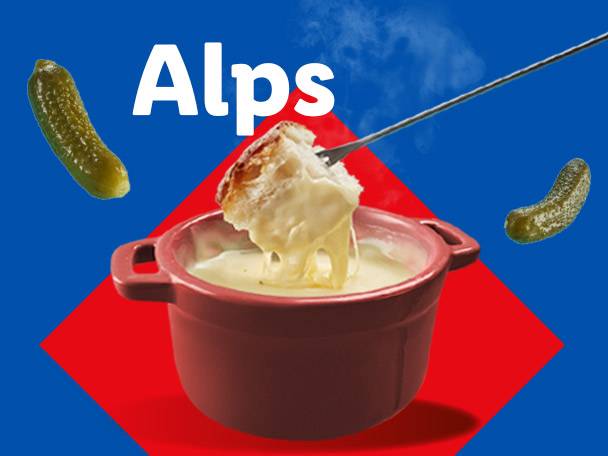 Fondue pot with bread and pickles, with the word 'Alps' above.