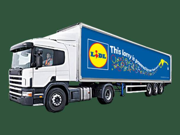 A white Lidl semi-truck with a blue trailer, stating 'This lorry is powered by our food waste'.