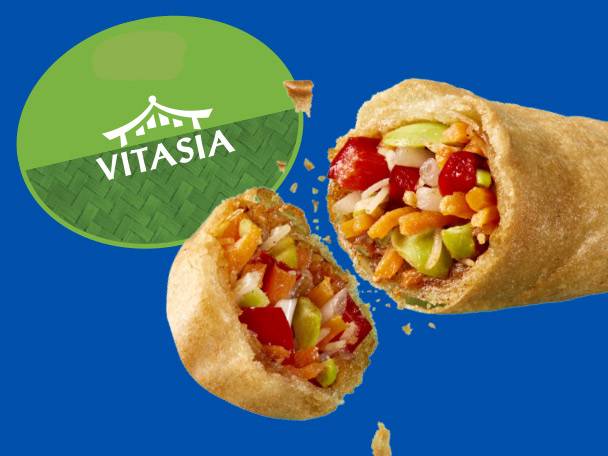 Two Vitasia spring rolls with visible vegetable filling on a blue background.