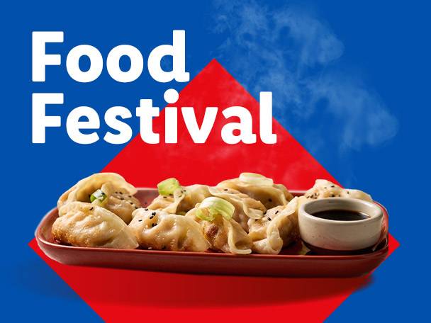 Food Festival: Steaming dumplings with soy sauce on a red and blue background.