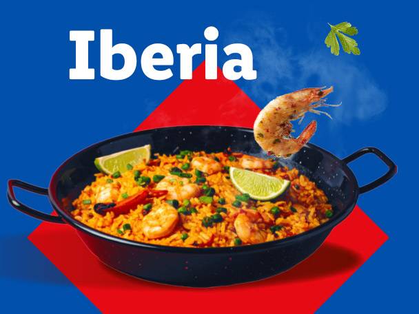 Paella with shrimp and lime in a black pan, with the word 'Iberia' above.