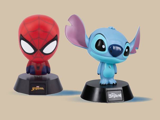 Two character figurines: a red superhero and a blue alien, both on black bases.