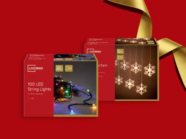Two boxes of LED Christmas lights on a festive red background with a gold ribbon.