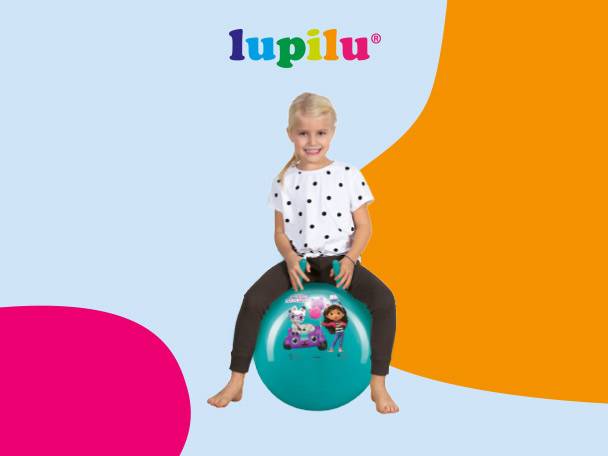 A young girl on a teal hopper ball with cartoon characters, against a blue and orange background.