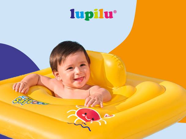 Smiling baby in a yellow inflatable baby float with a crab design.