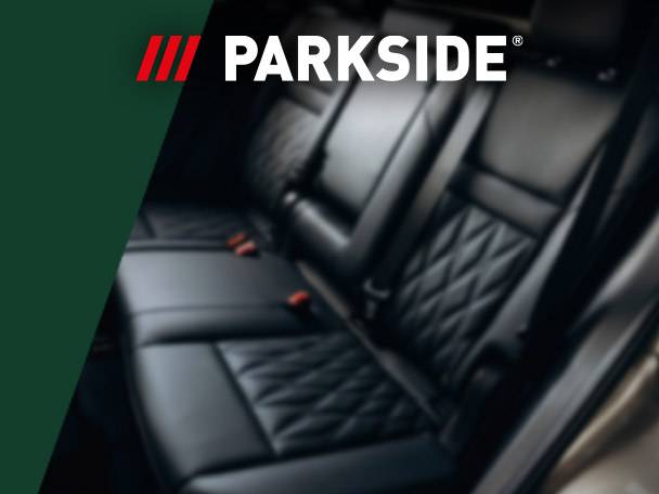 Car interior with black leather seats and a green overlay featuring the word 'PARKSIDE'.