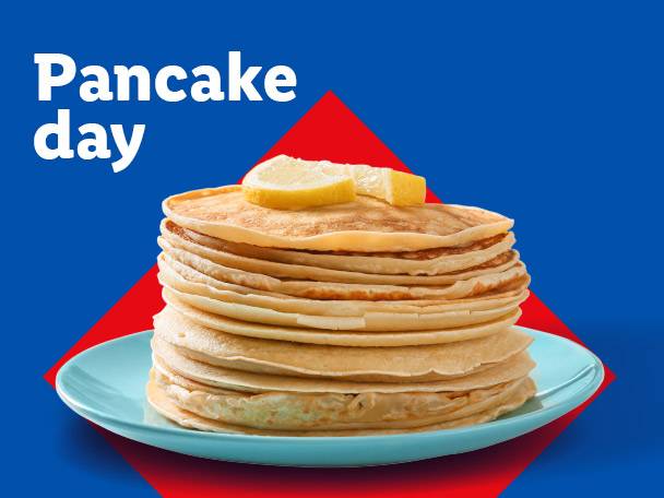 Stack of pancakes with lemon slices on a blue plate, with text 'Pancake day'.