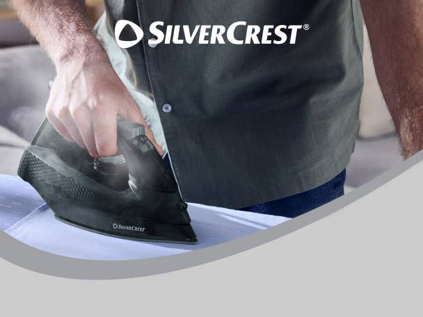 Man ironing a blue shirt with a black steam iron.
