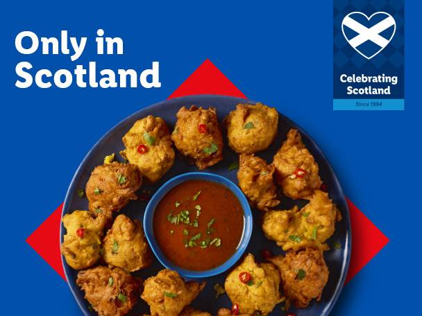 A plate of golden-brown pakora with a dipping sauce, text reads 'Only in Scotland'.