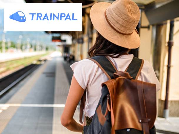 Woman with backpack and hat at a train station, Trainpal logo visible.