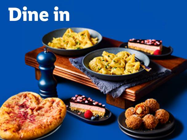 Dine in: Pasta dishes, heart-shaped pizza, cheesecake, and arancini on a blue background.