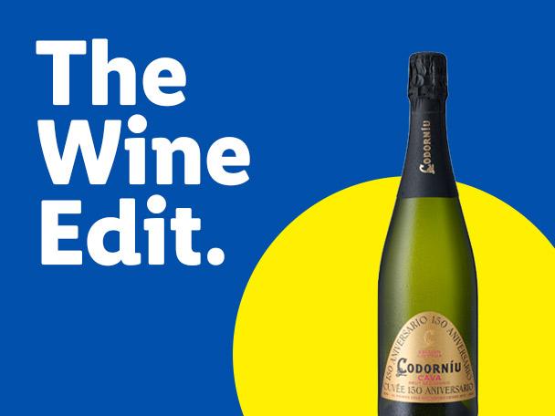 A bottle of sparkling Cava wine next to the text 'The Wine Edit.'