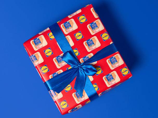 Lidl-branded gift wrap featuring chicken packaging, tied with a blue ribbon.