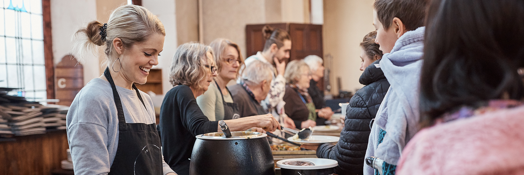 Food being served in a community dining hall.