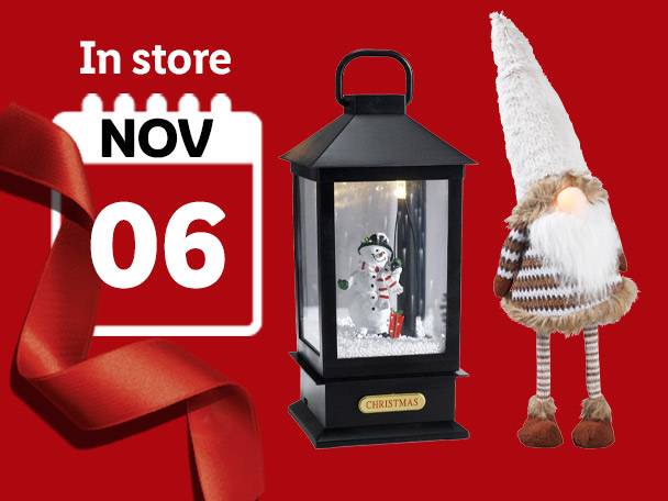 Christmas lantern with a snowman and a gnome, with a calendar showing 'NOV 06' and a red ribbon.