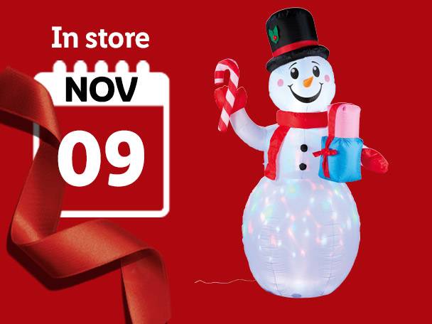 An inflatable snowman holding a candy cane and a gift, with a calendar showing 'In store NOV 09'.