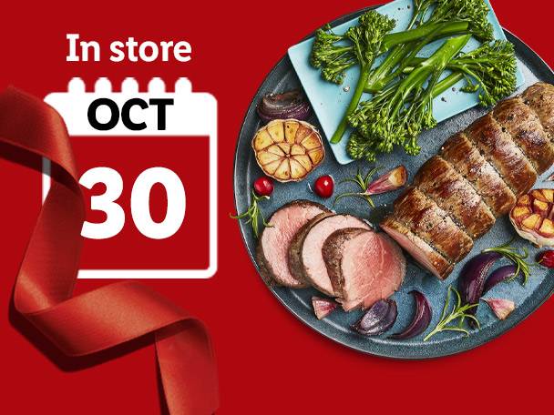 Roast beef with vegetables on a platter, with 'In store OCT 30' text and a red ribbon.