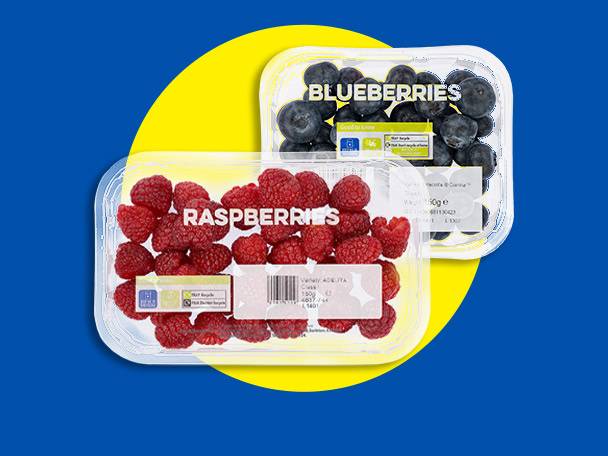 Two clear plastic containers of fresh berries: raspberries and blueberries, on a blue and yellow background.