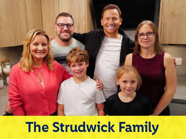 The Strudwick Family smiling together in a kitchen setting.