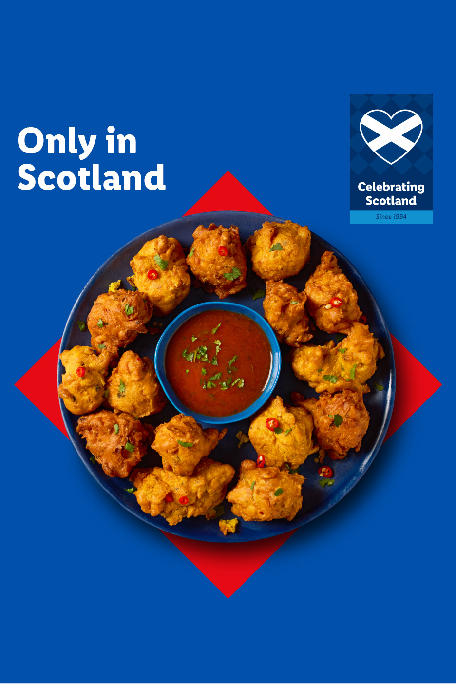 A plate of golden-brown pakora with a dipping sauce, set against a blue background with red accents and text 'Only in Scotland'.