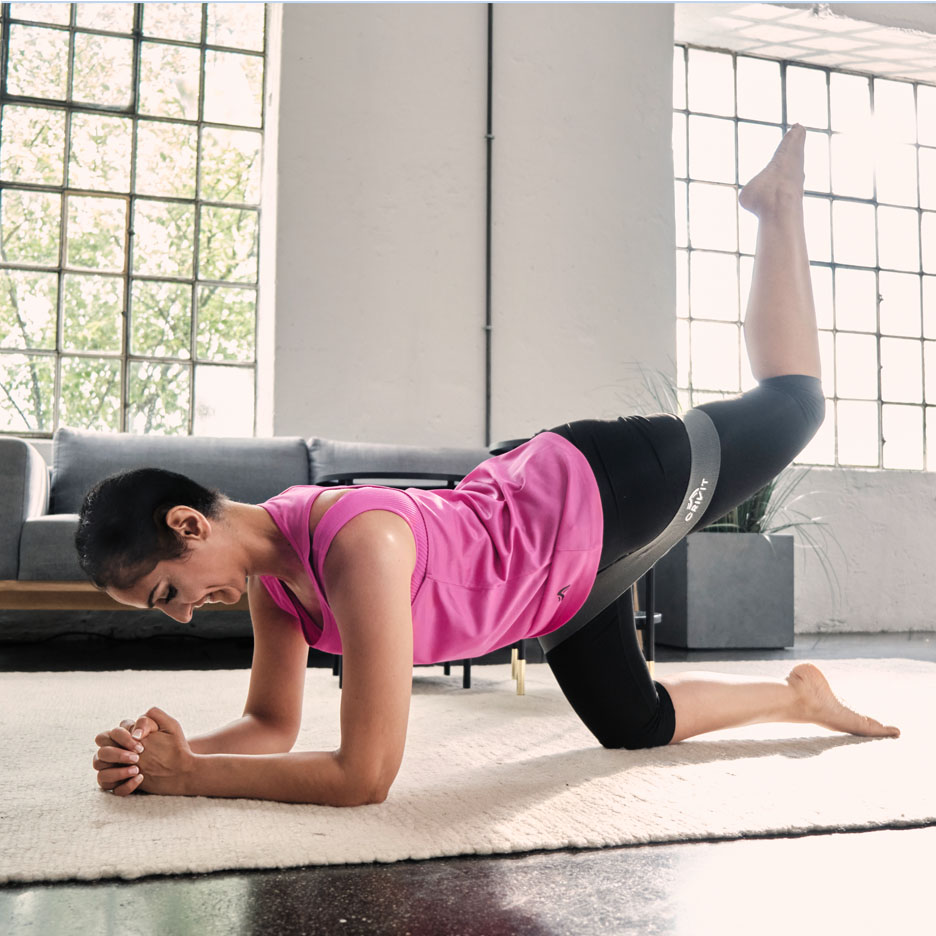 Woman doing leg exercises with Senfit resistance band.