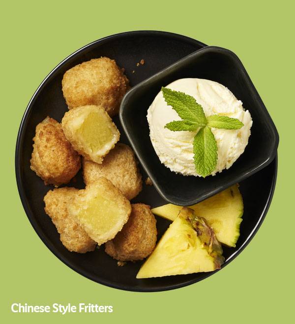 Chinese-style fritters served with vanilla ice cream and pineapple slices.