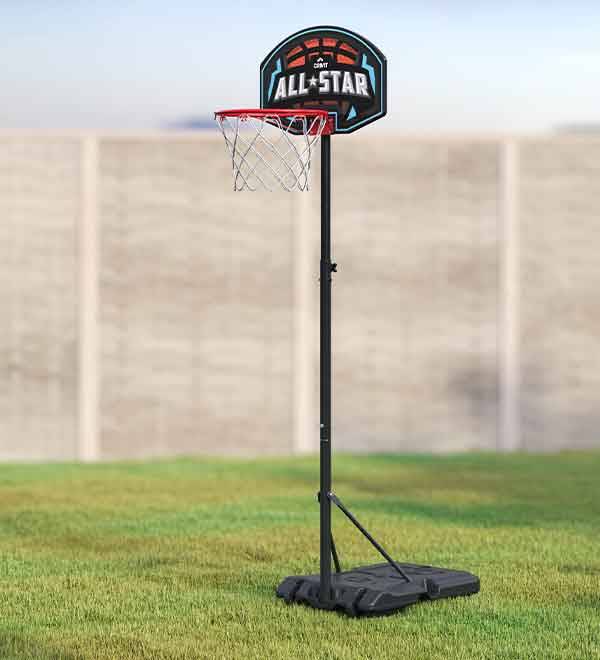 A SPALDING All-Star portable basketball hoop stands on a grassy lawn.