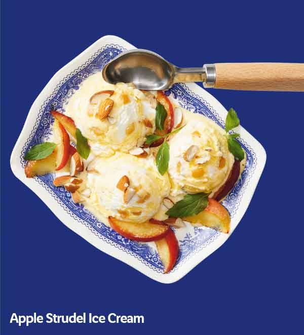 Apple strudel ice cream with apple slices, almonds, and mint on a decorative plate.