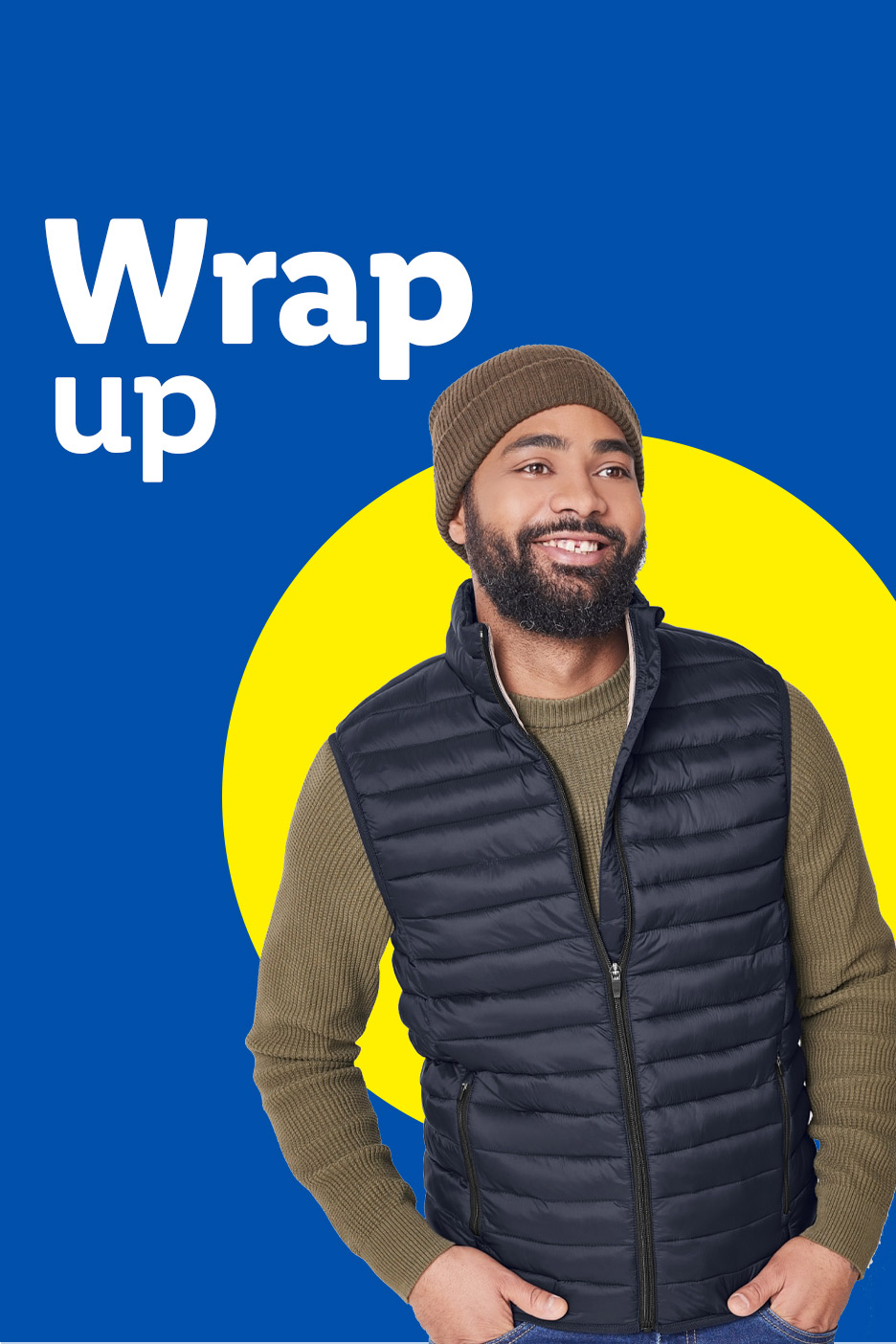 Man in a dark blue puffer vest, olive green sweater, and brown beanie, smiling against a blue and yellow background.
