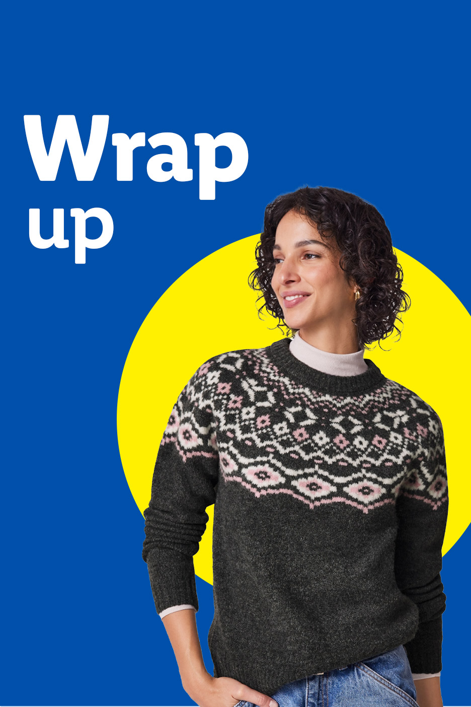 A woman in a fair isle sweater and jeans, smiling against a blue and yellow background.