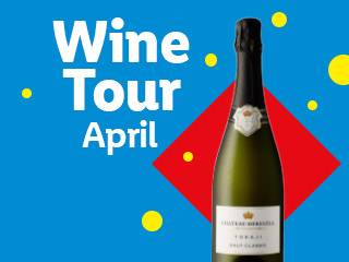 Sparkling wine bottle on a blue background with 'Wine Tour April' text.