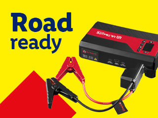 A portable jump starter with jumper cables, next to text that reads 'Road ready'.