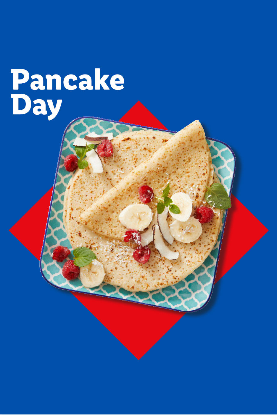 Pancakes with raspberries, banana, coconut flakes, and mint on a blue and red background.