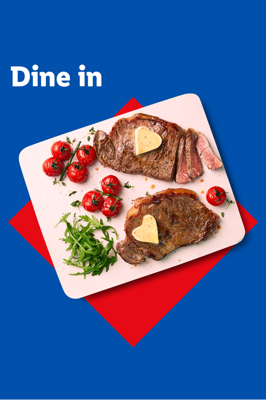 Two steaks with heart-shaped butter, cherry tomatoes, and rocket on a white board, with 'Dine in' text.