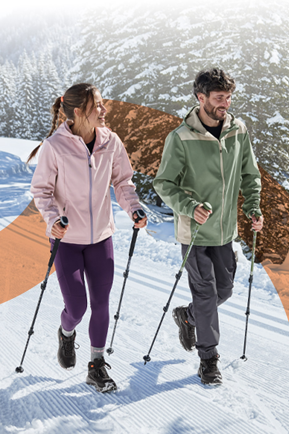 A man and a woman hiking in the snow wearing winter jackets and using trekking poles.