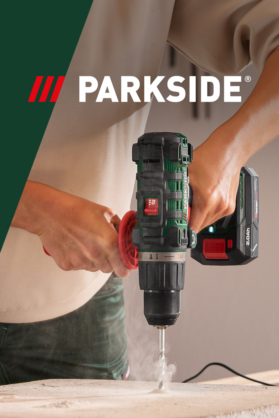 A person drilling into concrete with a cordless hammer drill.