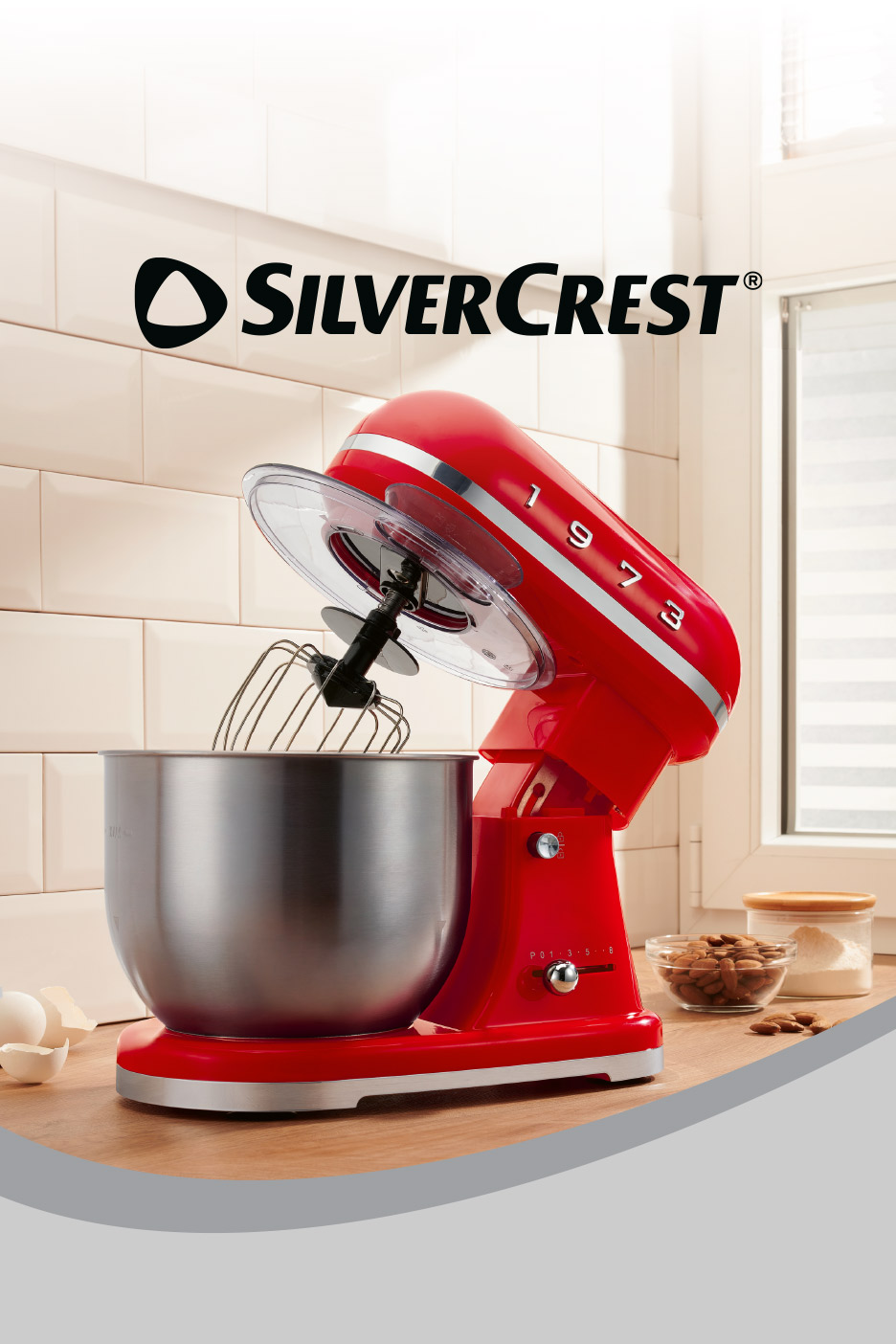 A red stand mixer with a stainless steel bowl on a kitchen counter.
