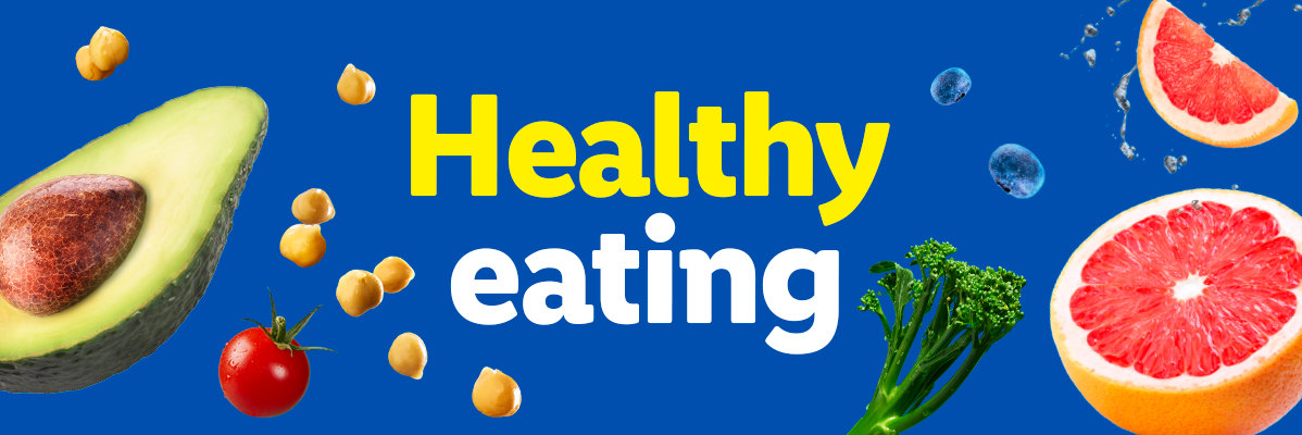 Healthy eating: avocado, grapefruit, chickpeas, tomato, broccoli, blueberries on blue background.