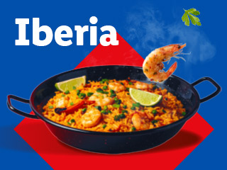 A paella dish with shrimp and lime, with the word 'Iberia' above it.