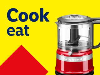 Red food processor on yellow background with text 'Cook eat' and red triangle.