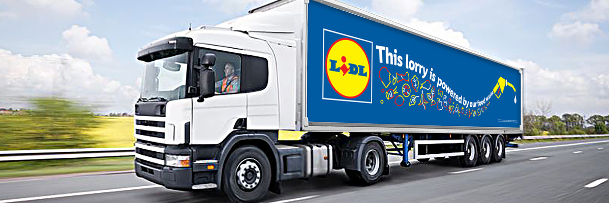 A Lidl lorry, powered by food waste, drives on a highway.