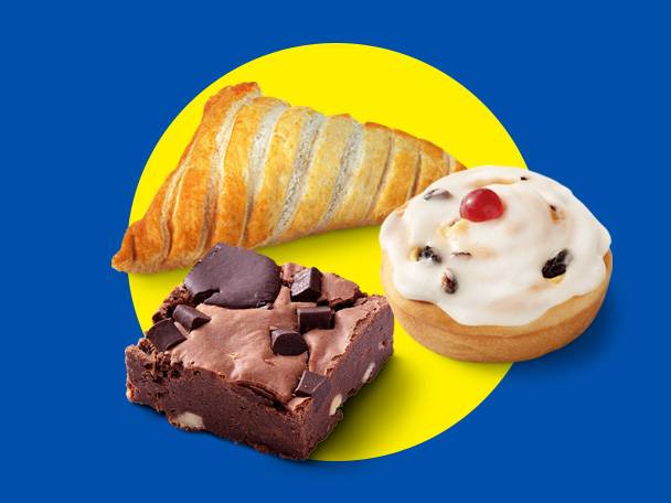 A golden pastry, a chocolate brownie, and a frosted bun with a cherry on a yellow circle.