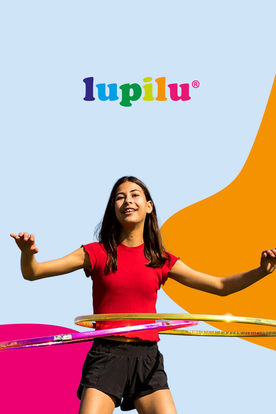 A young girl in a red shirt and black shorts hula hooping outdoors, with colorful shapes.